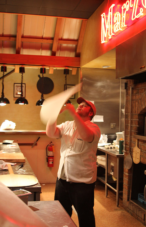 Pizza dough being tossed